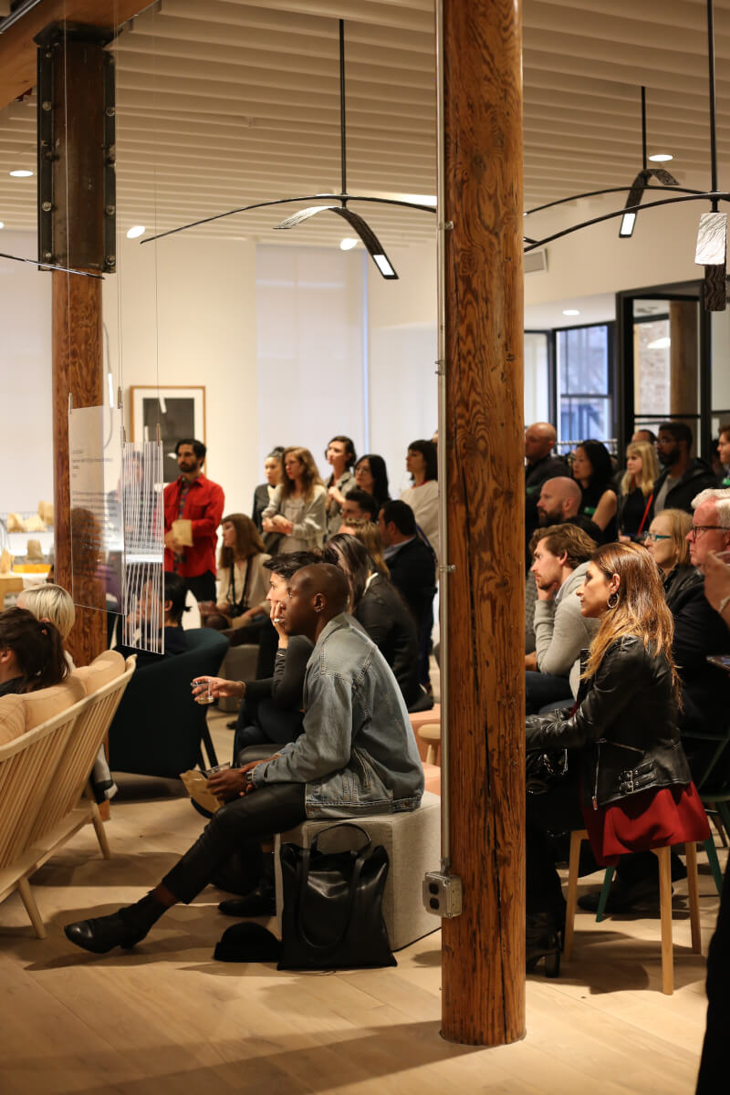 People listening to panel discussion under Rich Brilliant Willing´s OLED fixture “Light Inflection”