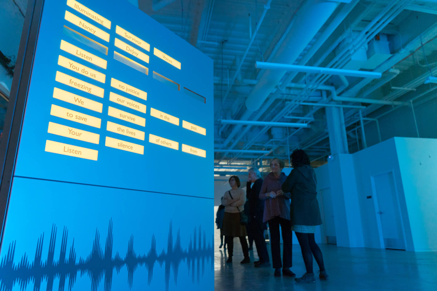 The poem Illuminating Survivor Voices displayed as an OLED light installation presented on a hollow metal frame filled with OLED panels