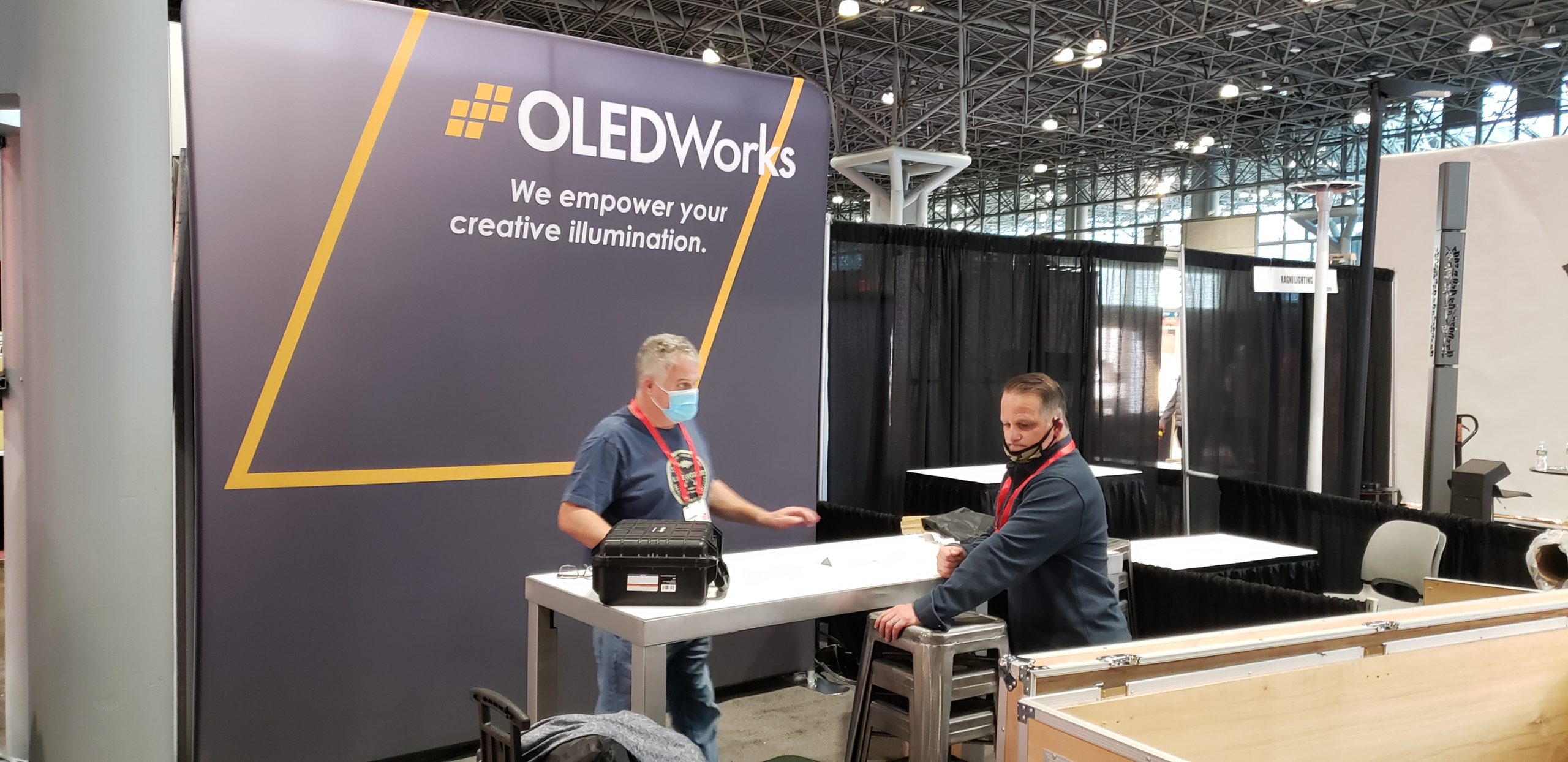 OLEDWorks team setting up booth at LightFair